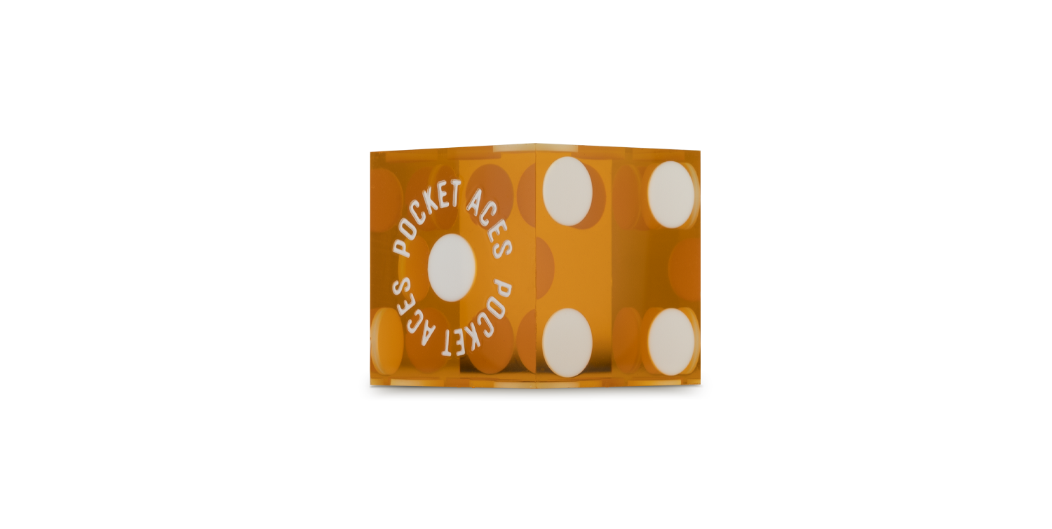 A polished casino die in an honey color