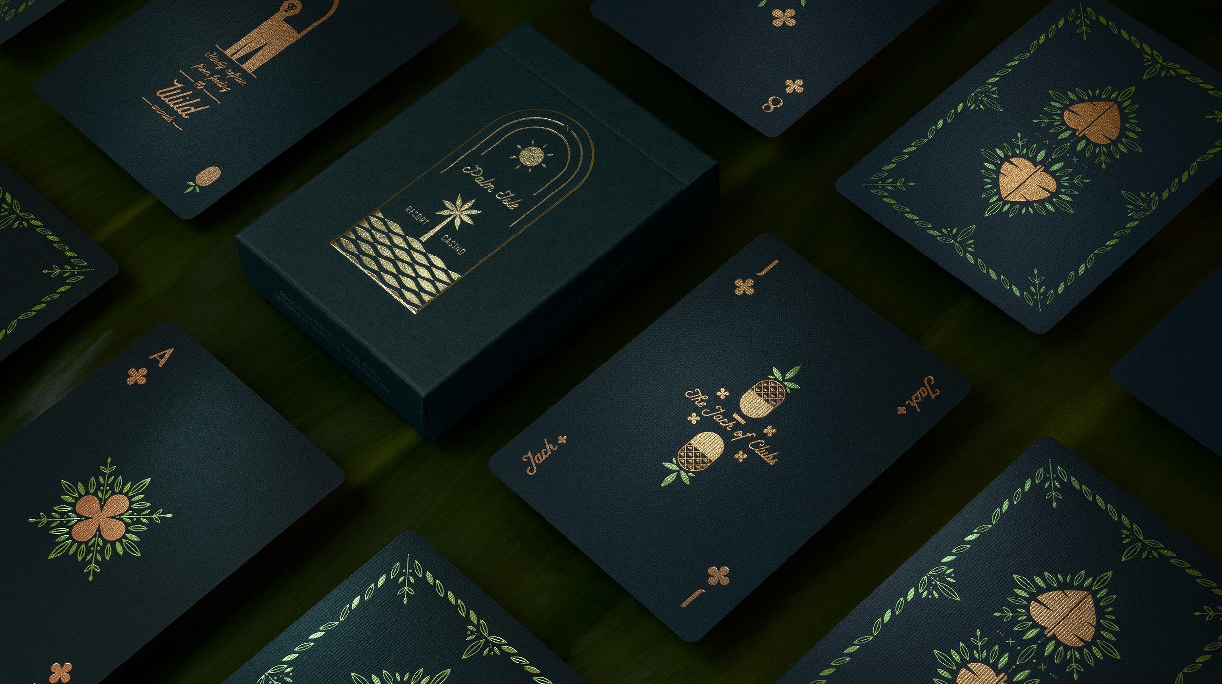A deck of green playing cards on palm fronds