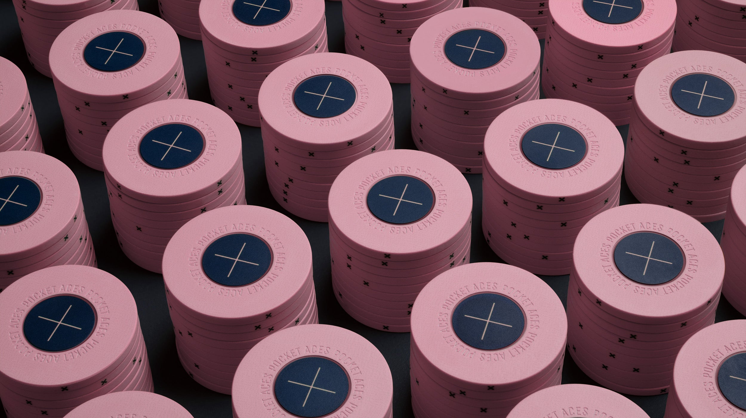 Rows of bubblegum colored poker chips on a table