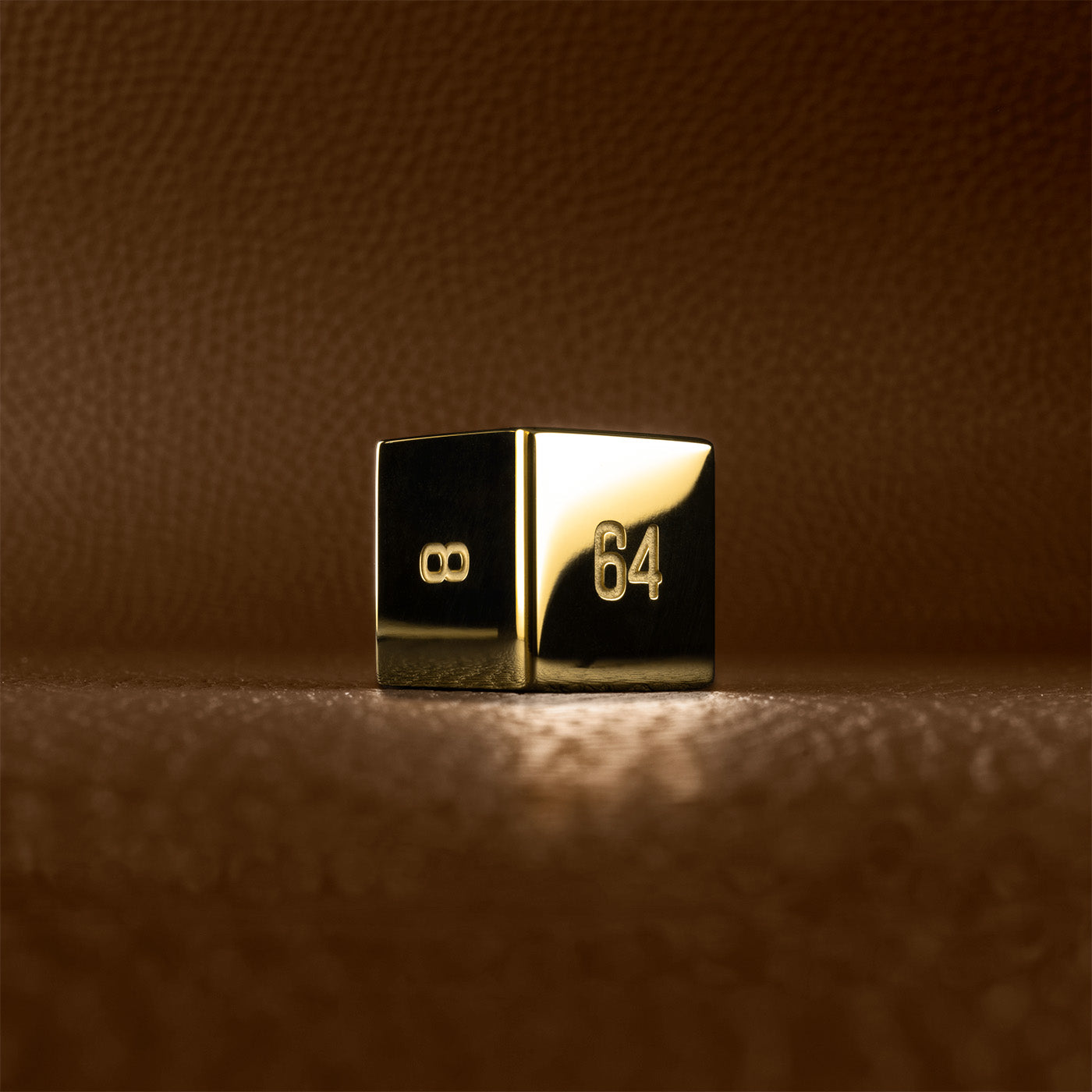 A polished gold doubling cube