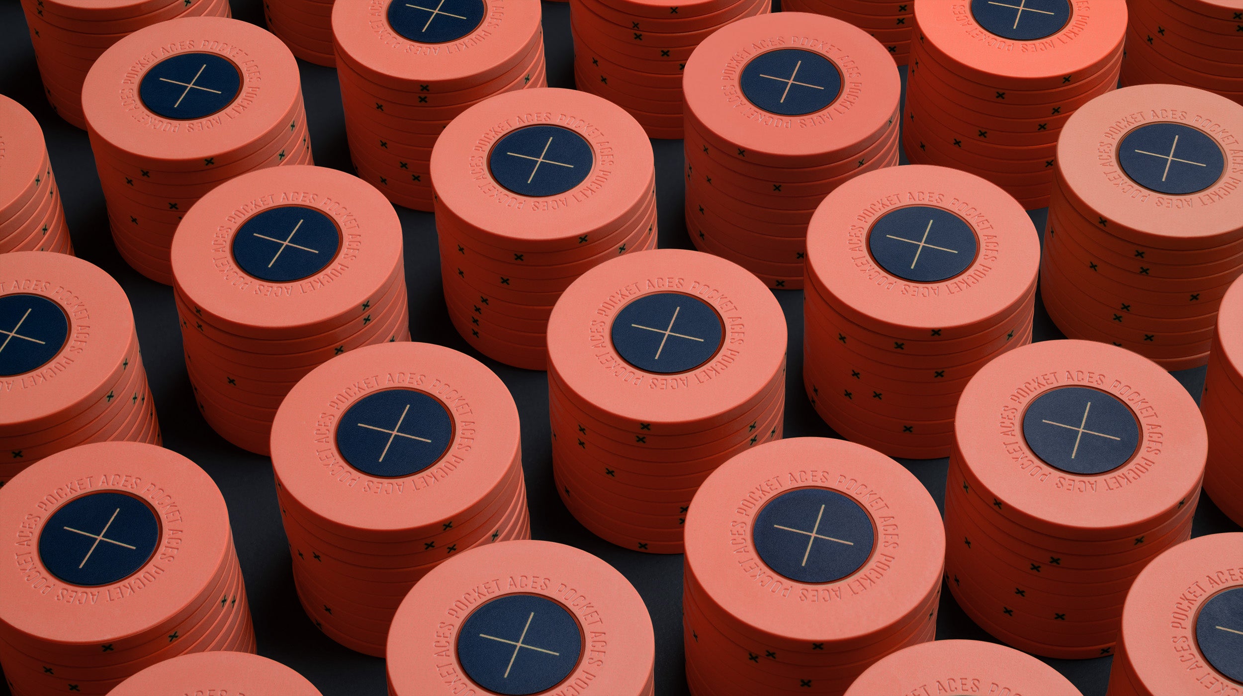 Rows of coral colored poker chips on a table