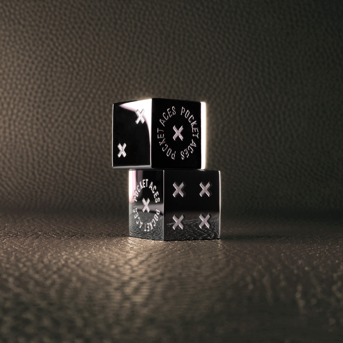 A set of polished stainless steel dice