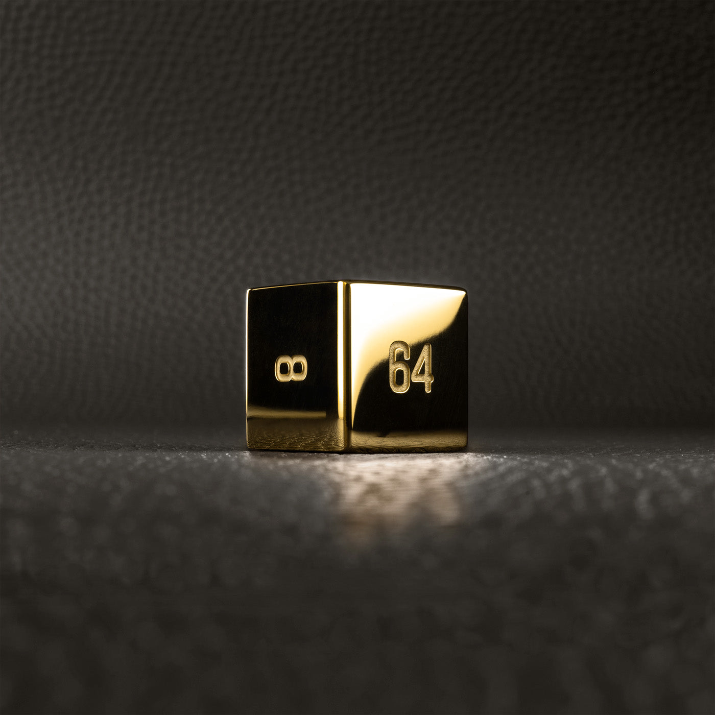 A polished gold doubling cube