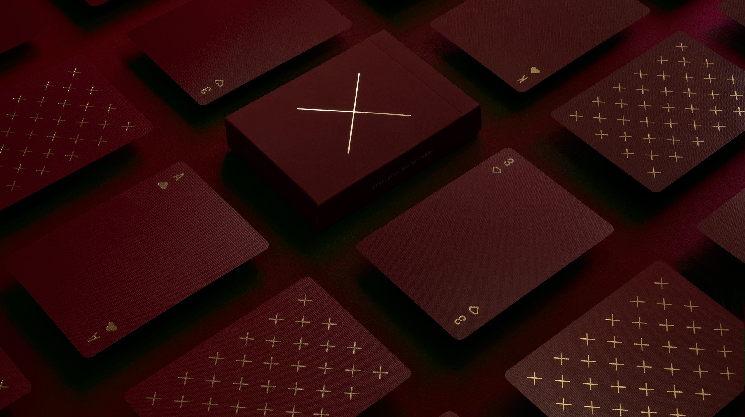 A maroon and gold deck of cards on a table