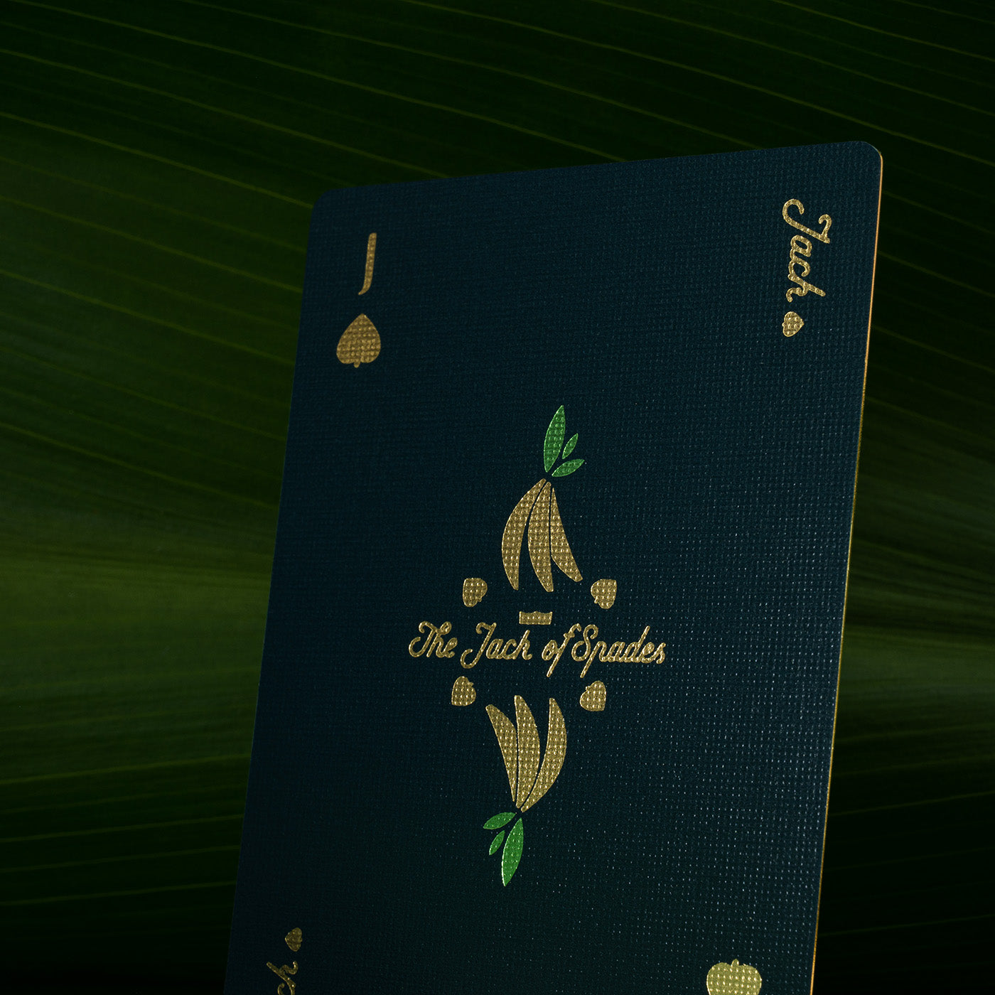 A playing card against a backdrop of palm fronds