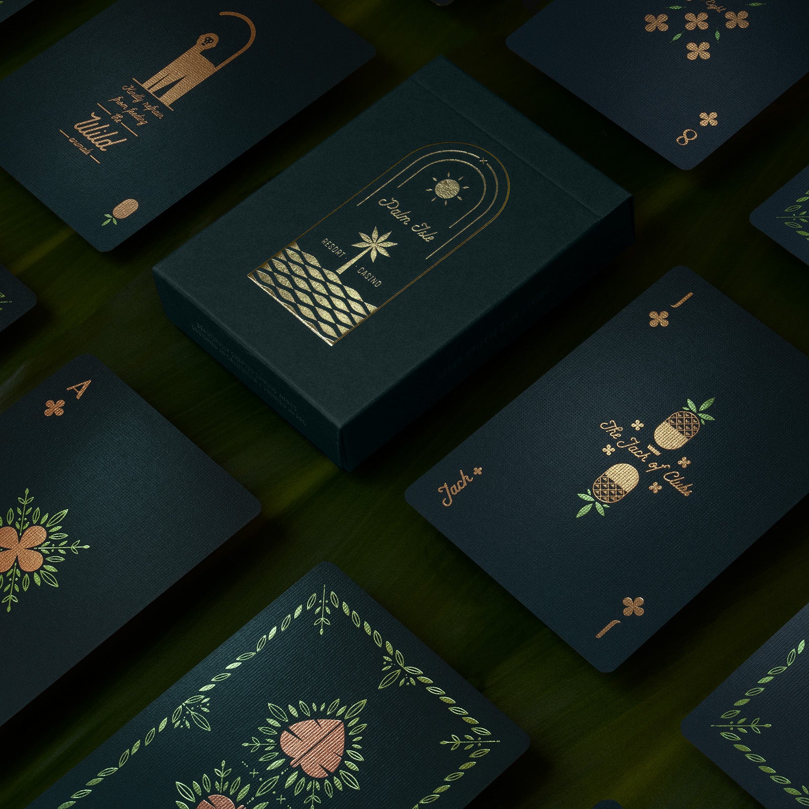 A deck of green playing cards on palm fronds