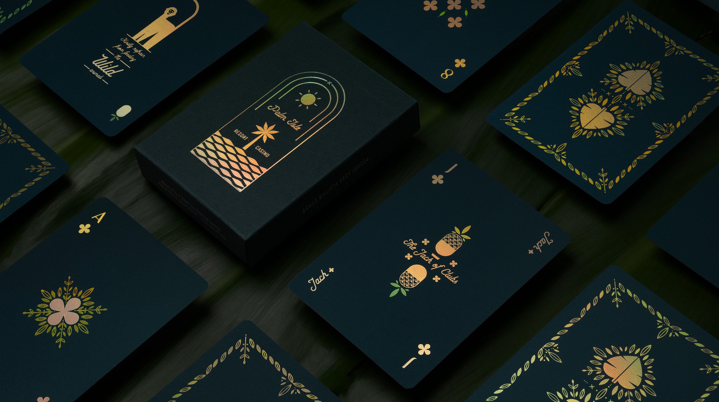 A green deck of cards on top of palm fronds