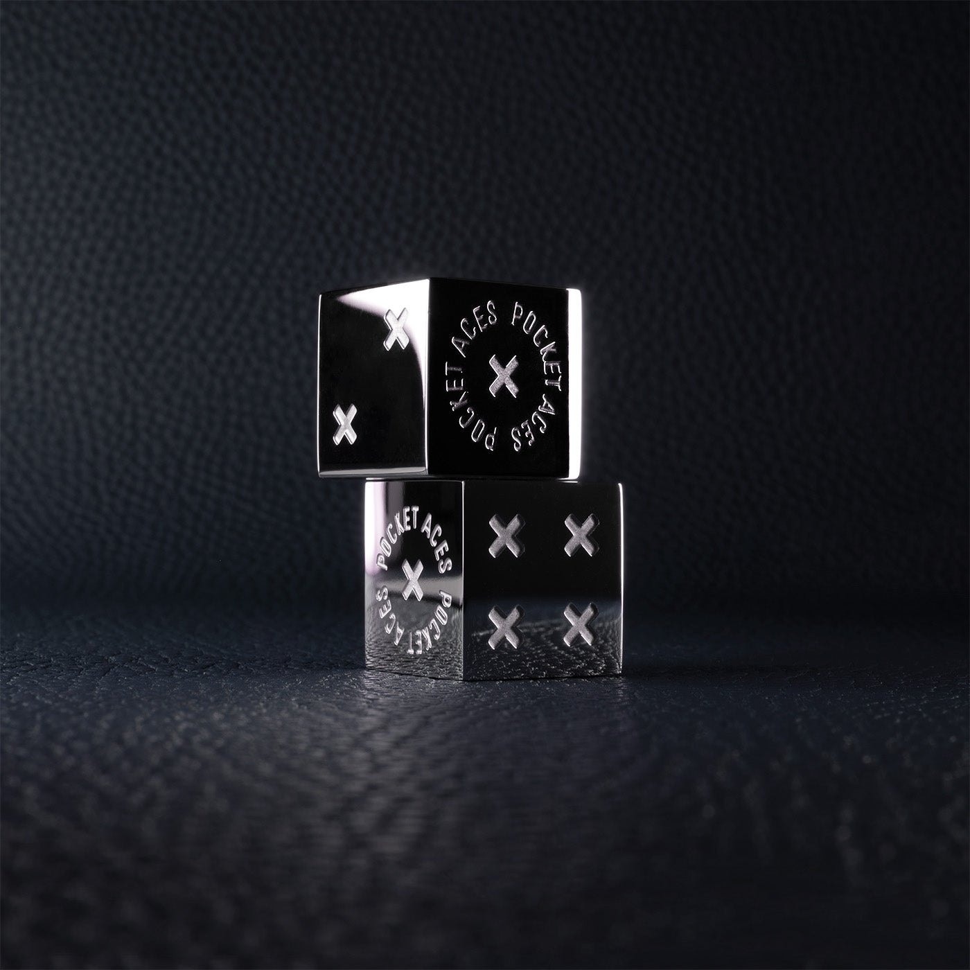 A set of polished stainless steel dice