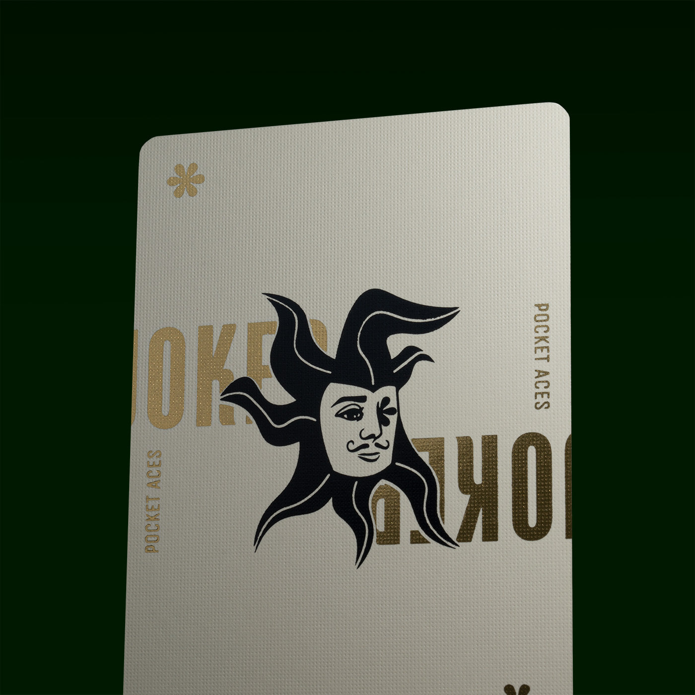 A white and gold joker card