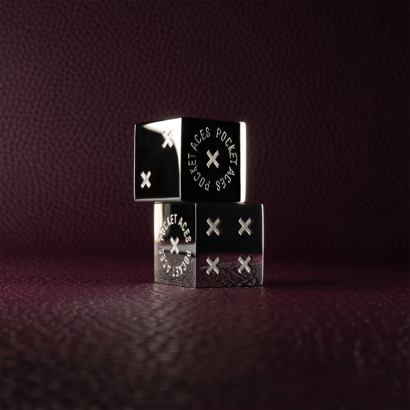 A set of polished stainless steel dice