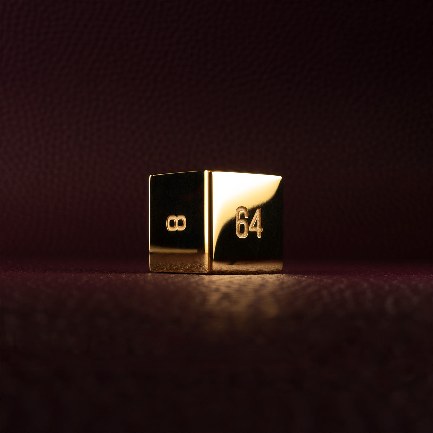 A polished gold doubling cube