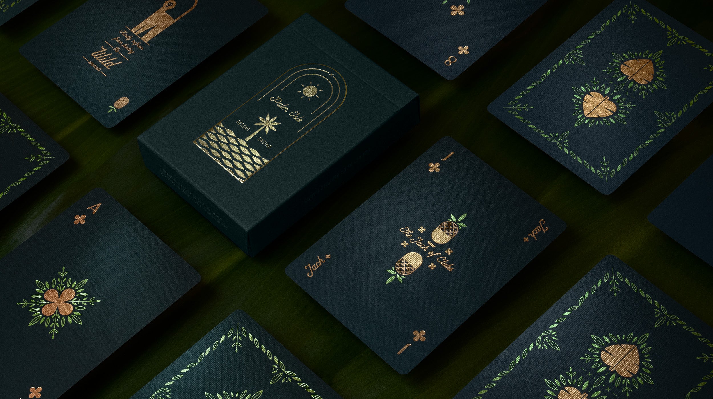 A deck of green playing cards on palm fronds
