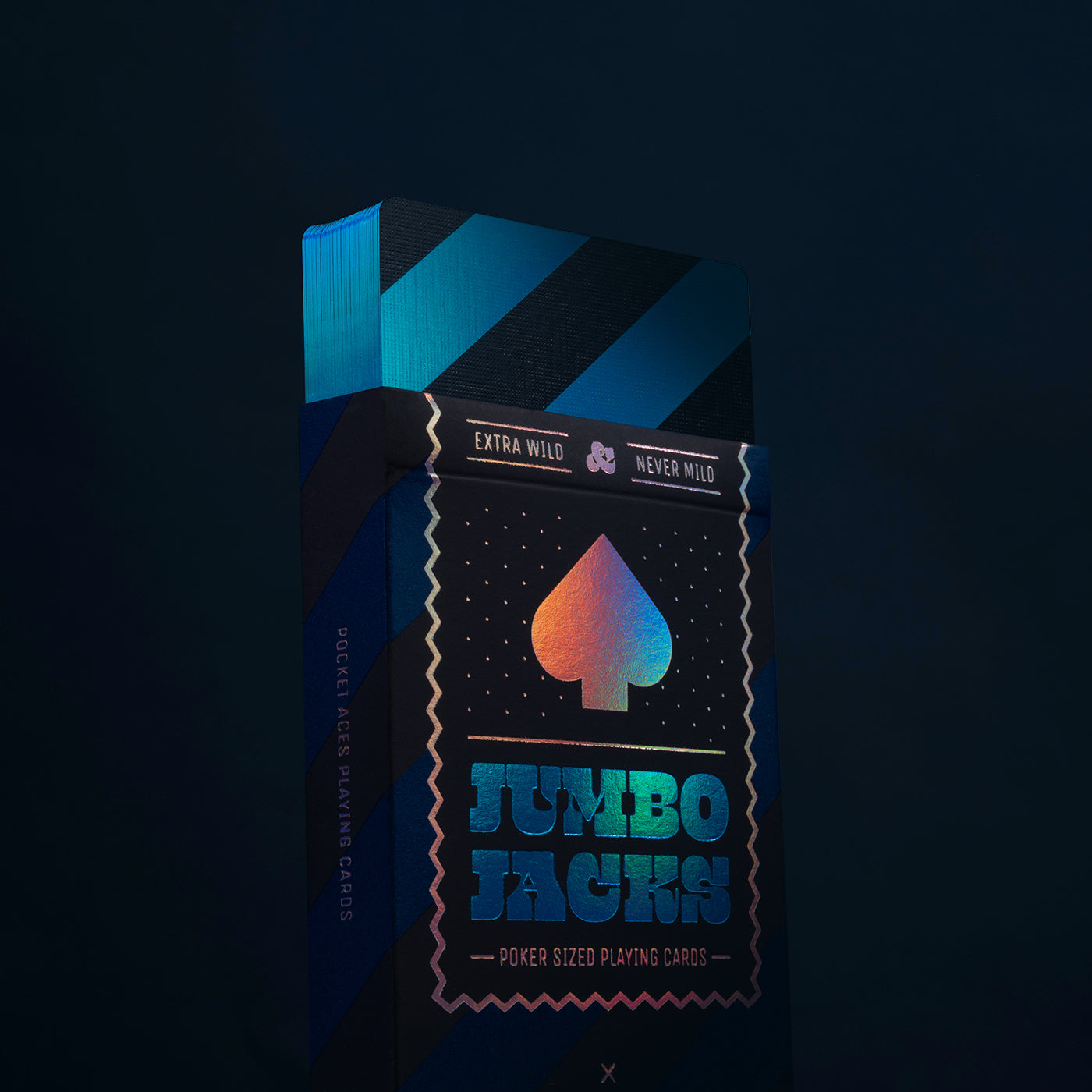 Playing card box with geometric design and colorful spade symbol on a dark background