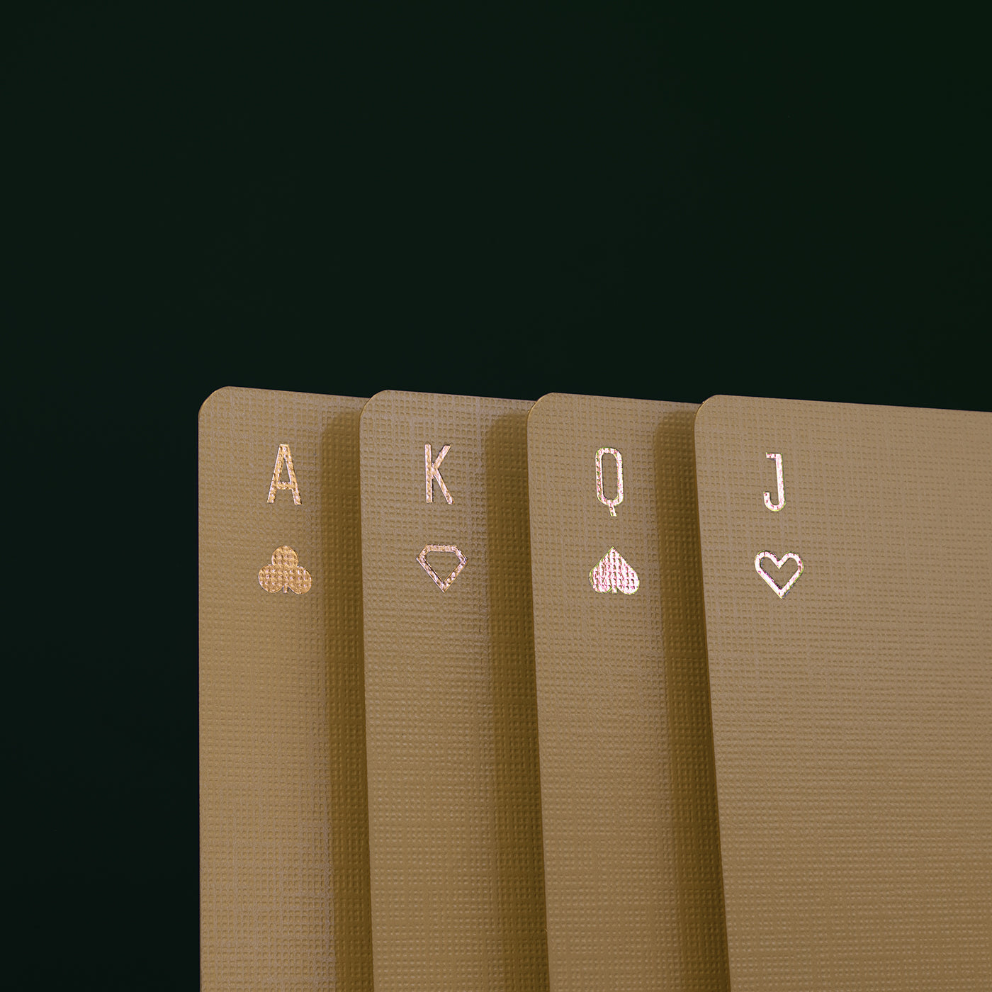Four playing cards with champagne colored foil