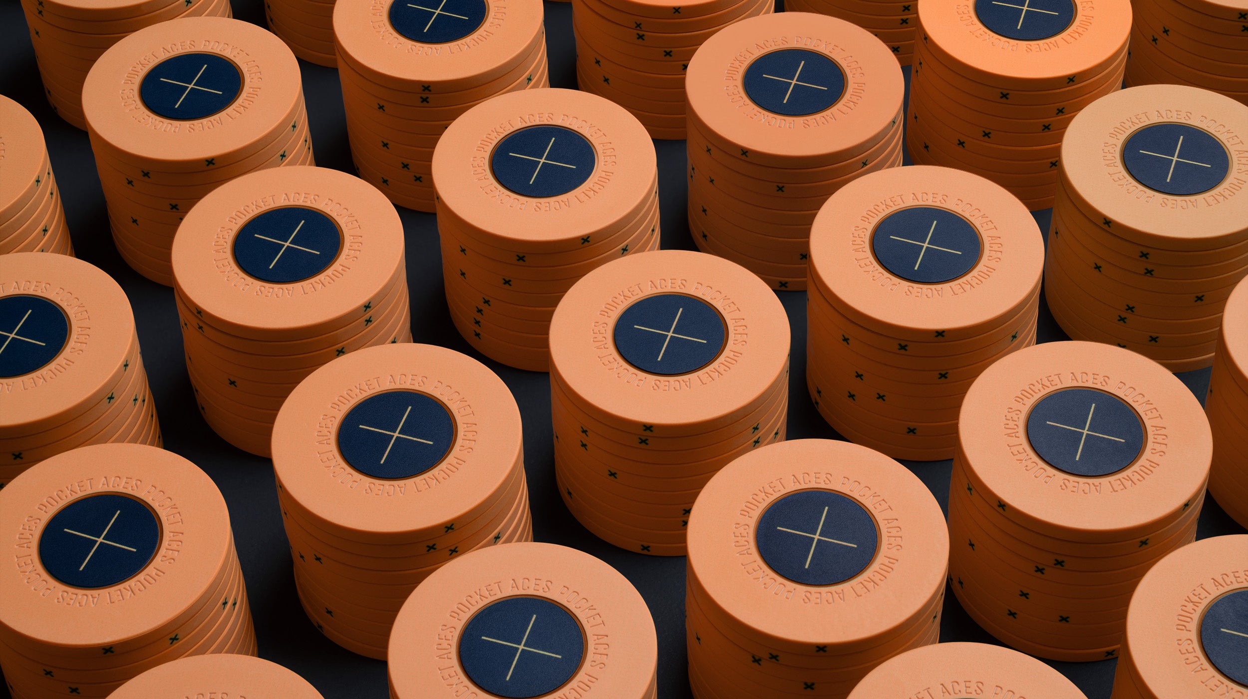 Rows of peach colored poker chips on a table