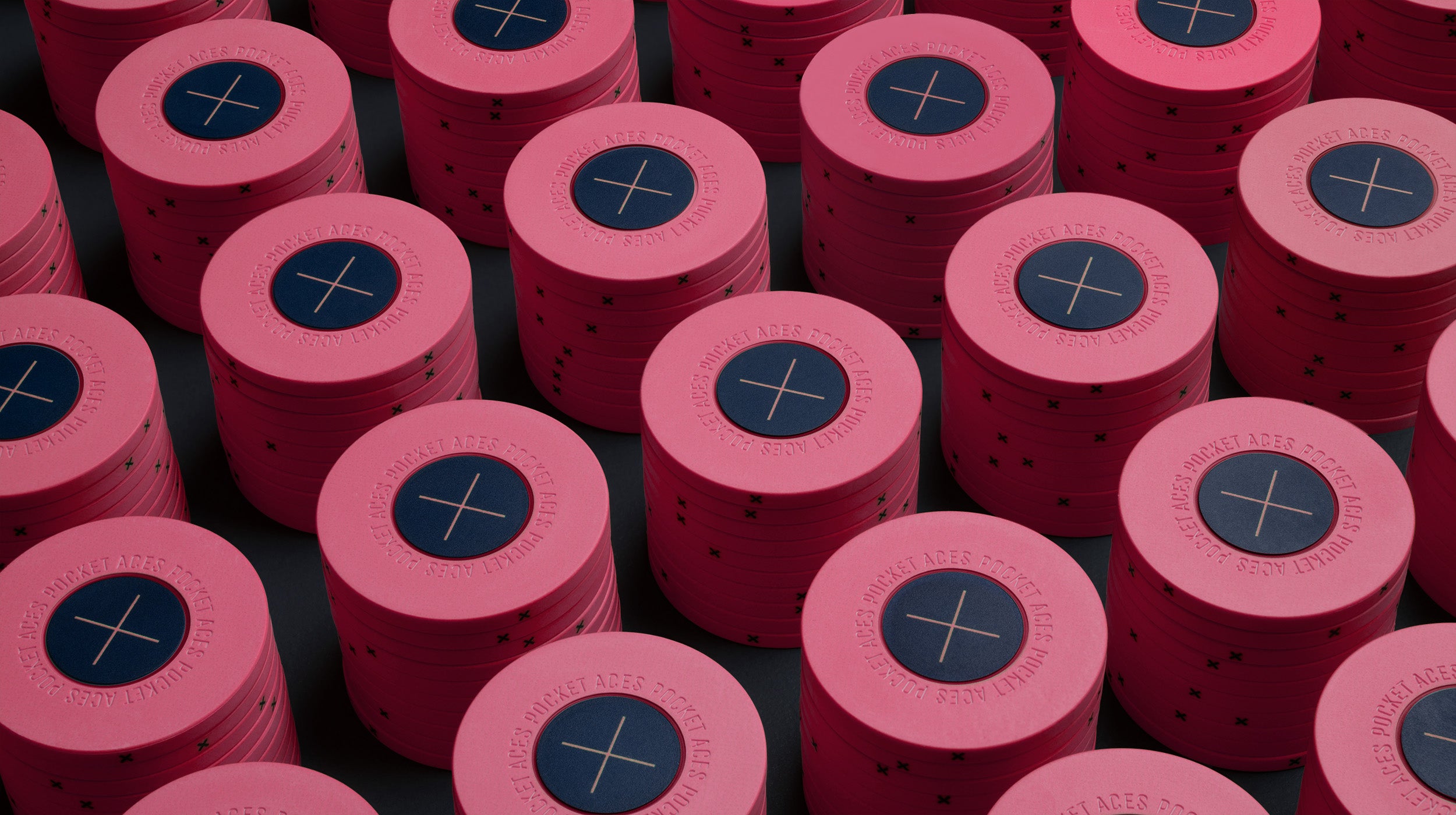 Rows of pink colored poker chips on a table